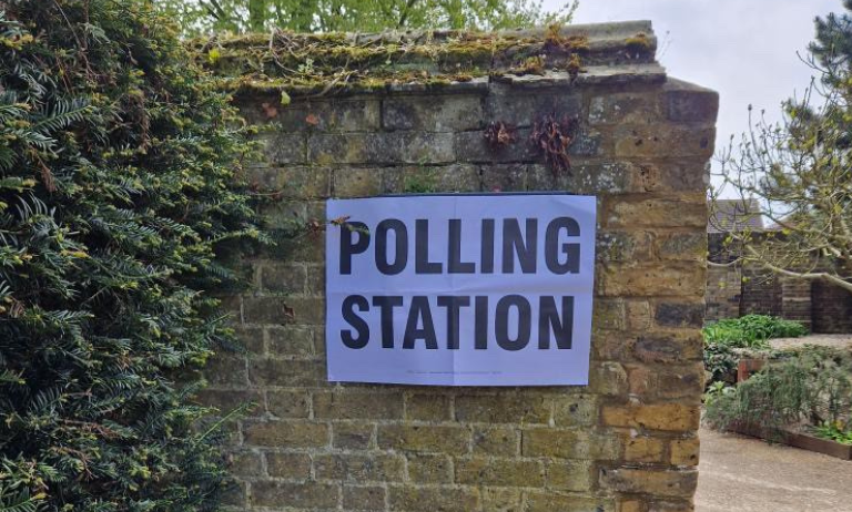 Polling station sign on a wall