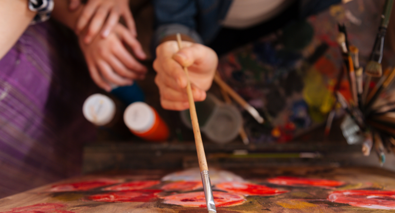 A paintbrush being applied to a canvas
