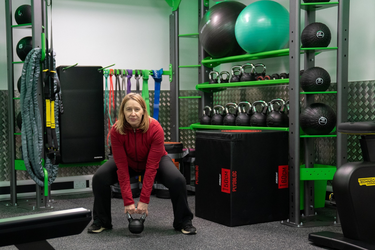 A Woman Uses The Free Weights Section At South Woodham Ferrers Gym