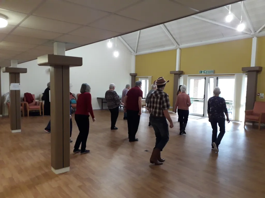 Residents In CHP Communal Lounge Line Dancing