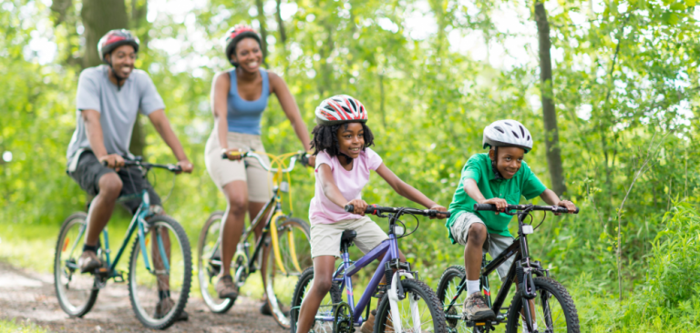 Family cycling through forest