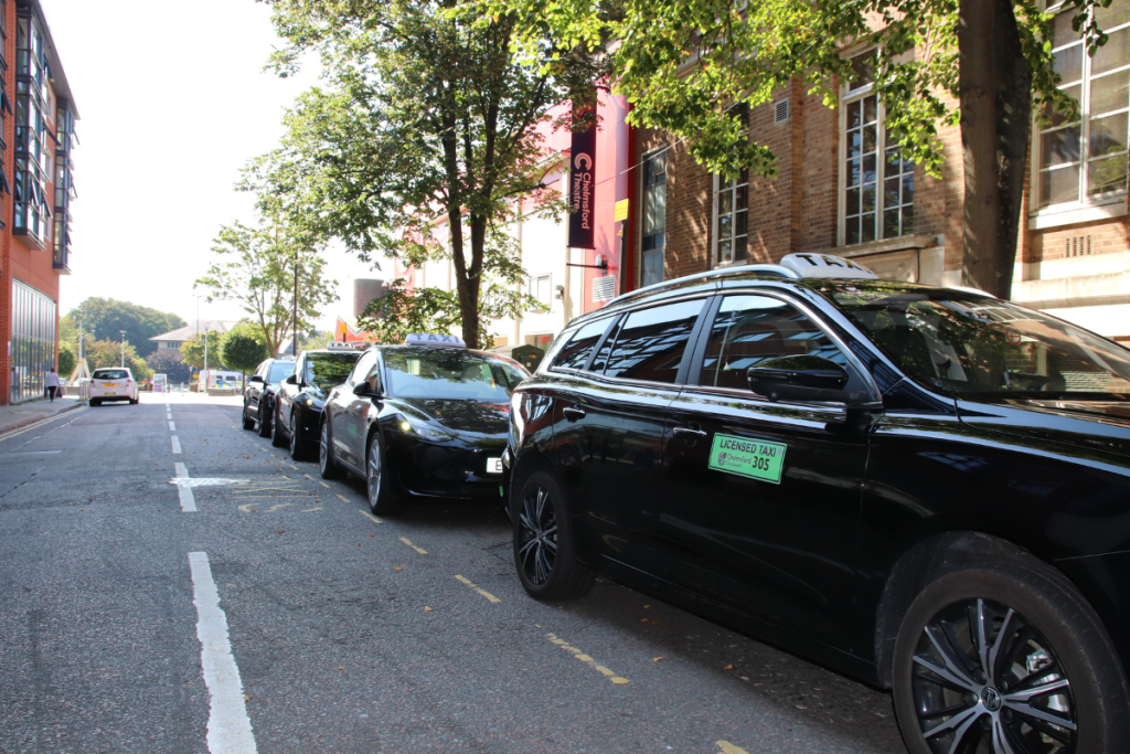 Electric Taxis, With Their Green License Badges, Are Seen At Fairfield Road Taxi Rank