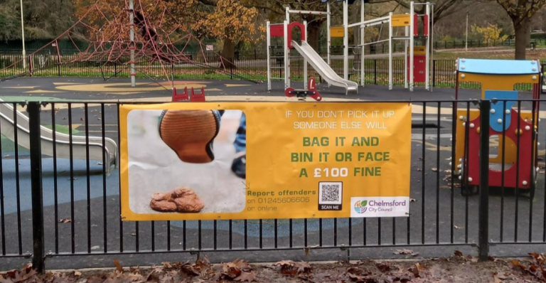 Advertising banner on railings, telling people to bag it and bin it, or face a £100 fine