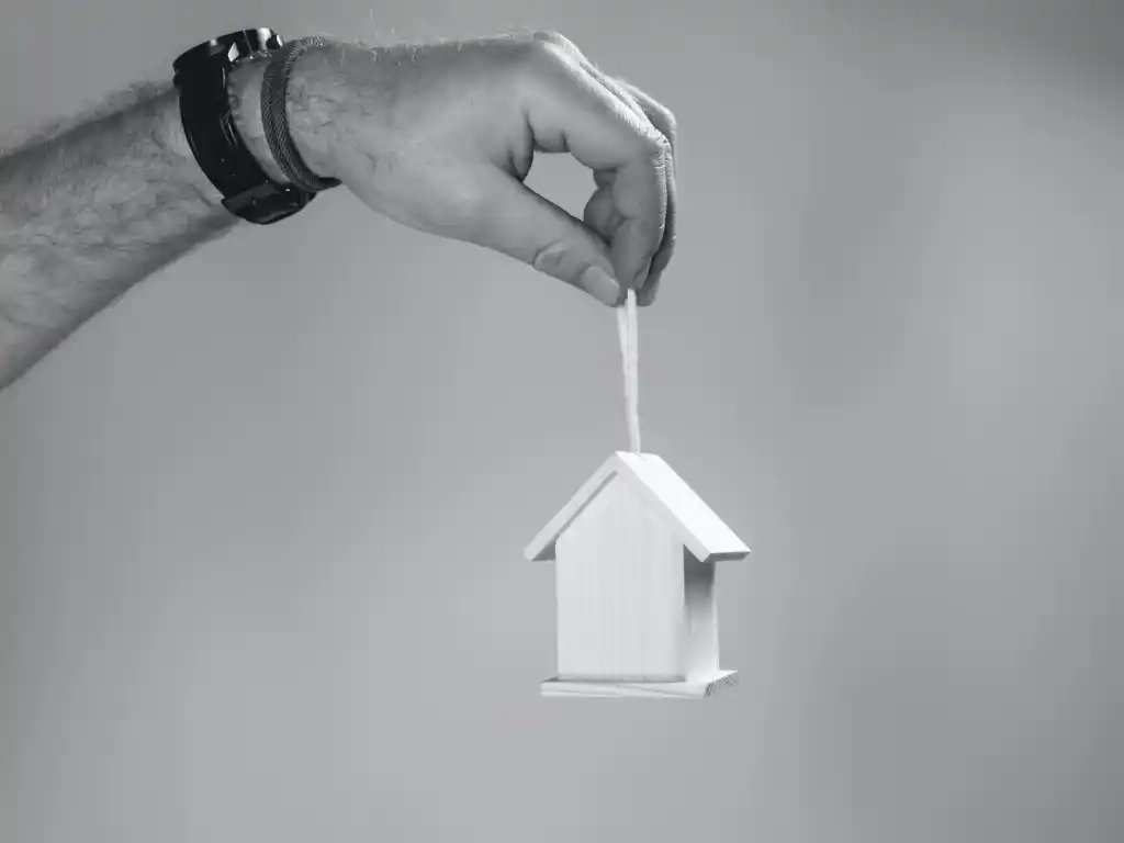 Mini House Ornament Being Held In The Air
