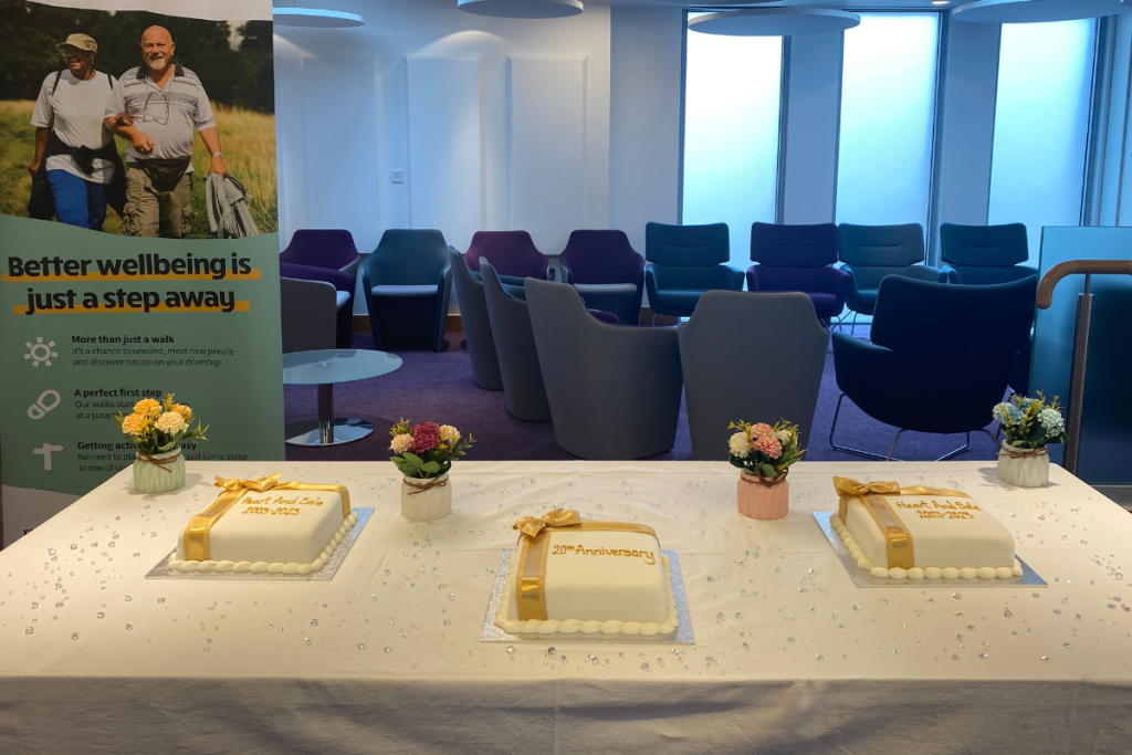 3 White Cakes With Gold Bows And Writing Are On A Table, With Flowers