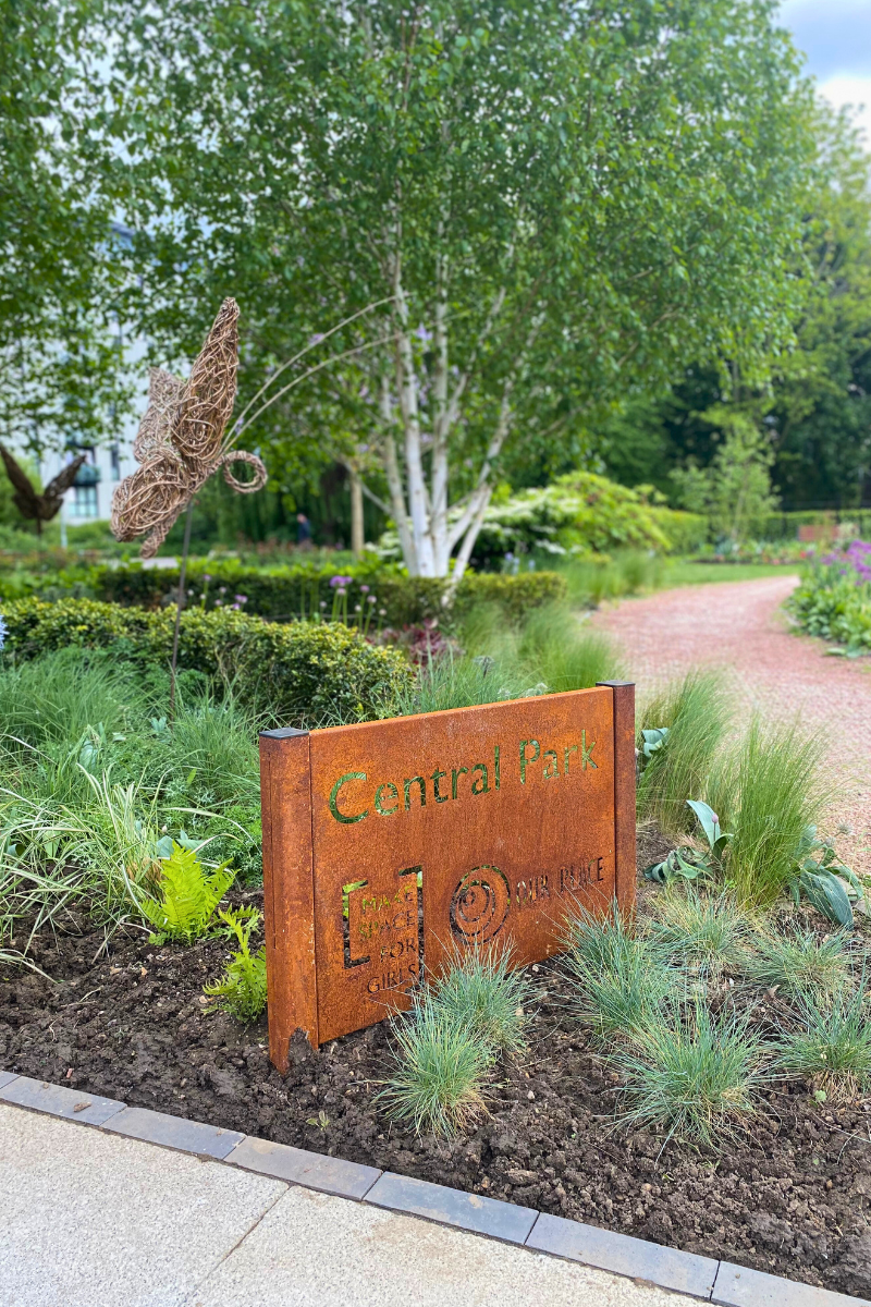 A Sign Reads 'Central Park Our Place' Alongside The Make Space For Girls Logo