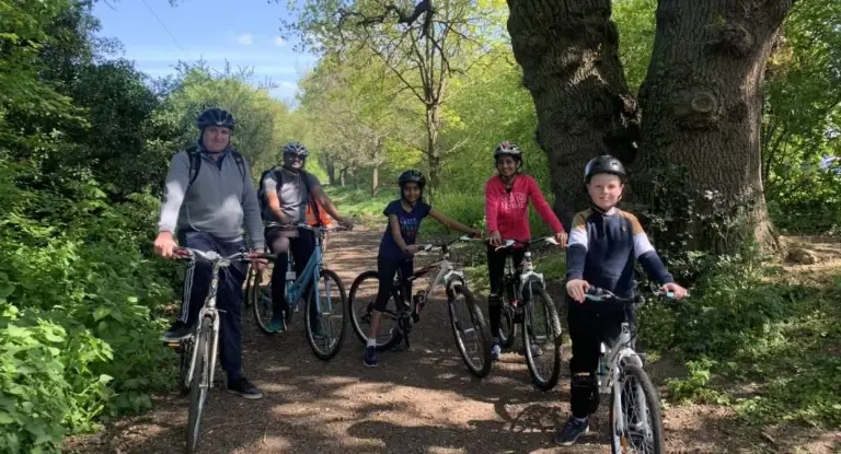 A Family Pose With Their Bikes