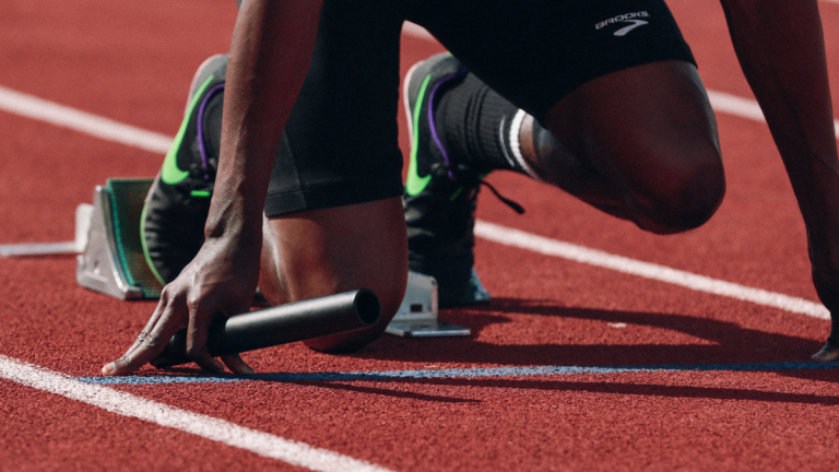 A Sprinter Prepares To Start A Relay