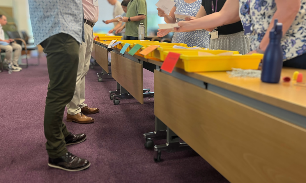 Ballot papers being sorted into trays.png