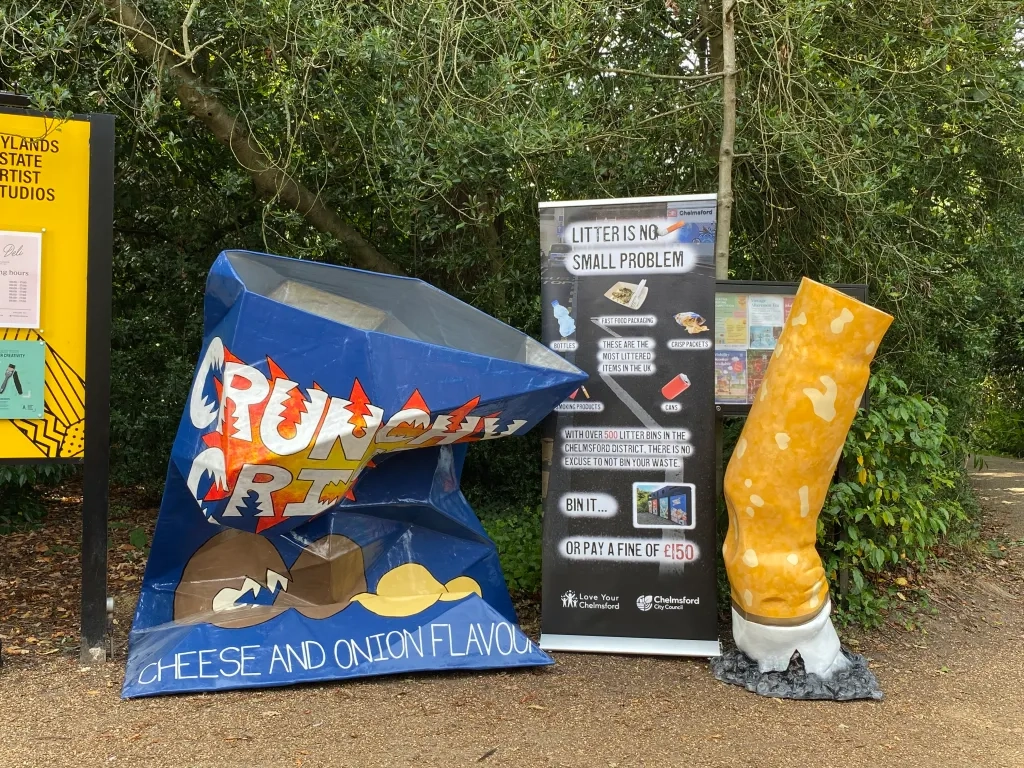 Litter campaign - large crisp packet and cigarette with sign