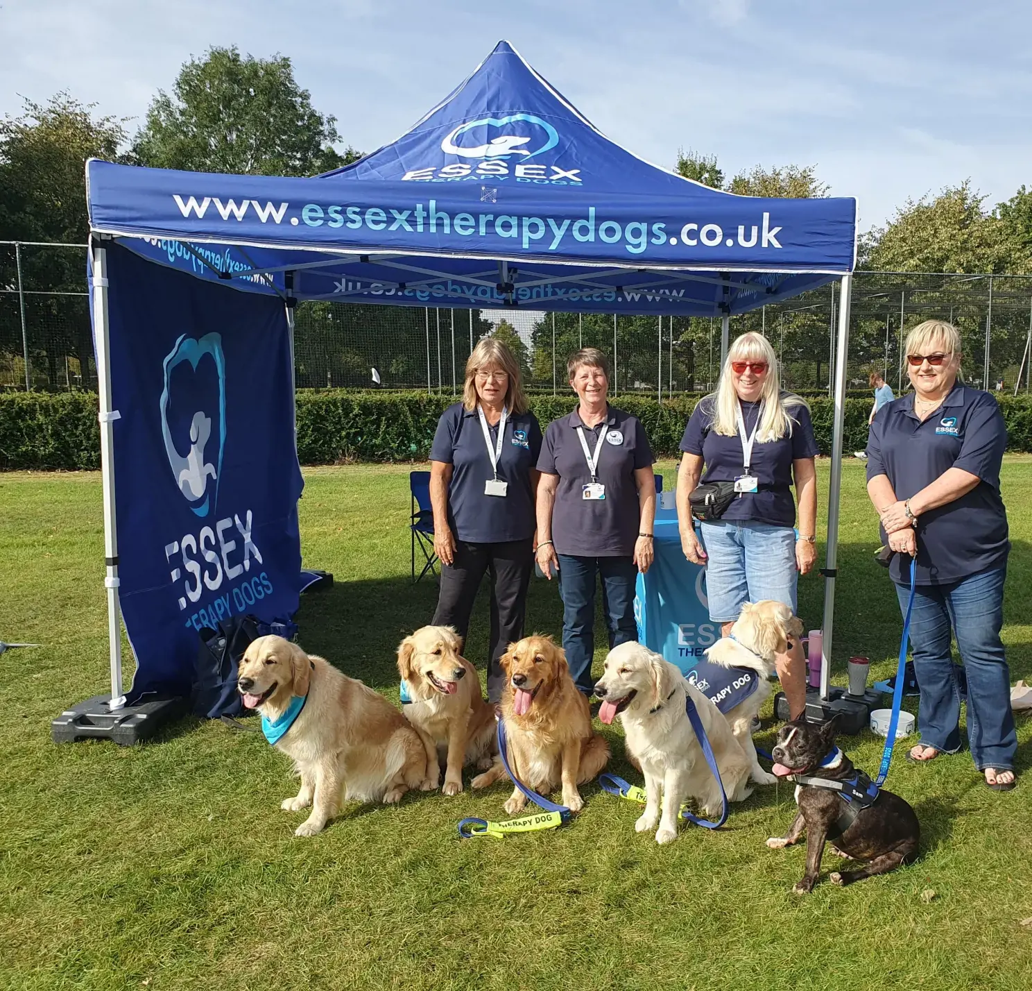 Six Dogs And Four Humans From Essex Therapy Dogs Are Pictured At Their Event Gazebo