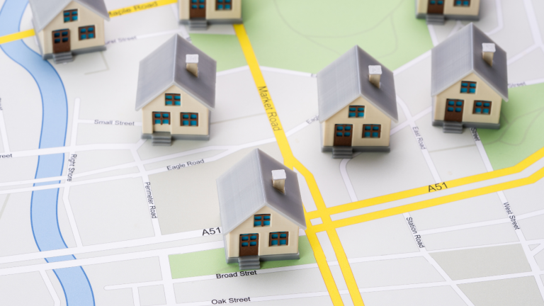 Computer Generated Image Of Oversized Houses On A Road Map