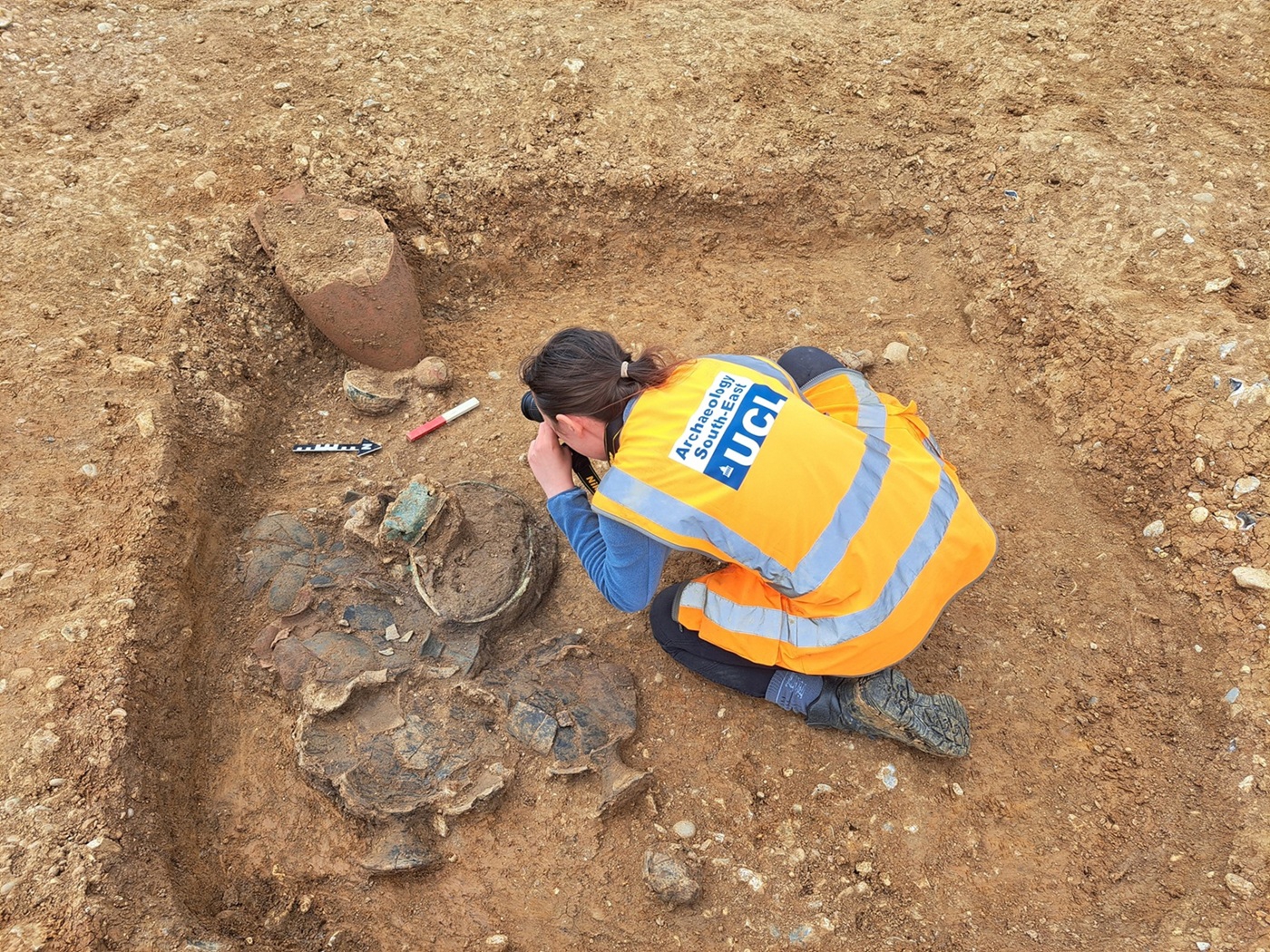 Archaeology South-East cremation burial pit 1_2 being recorded.jpg