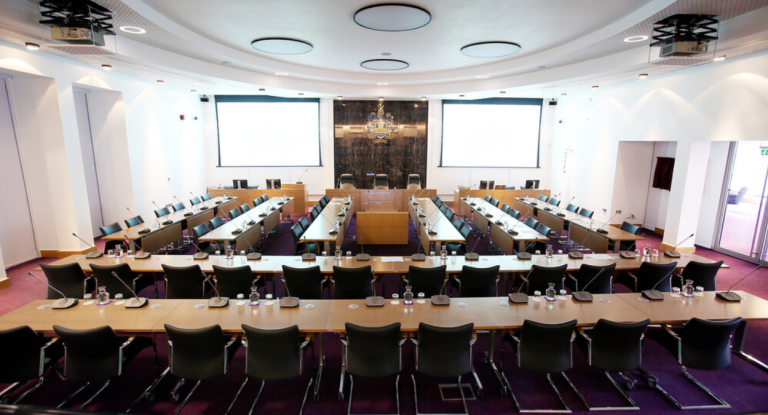 Tables and chairs set out in Chamber ready for meeting