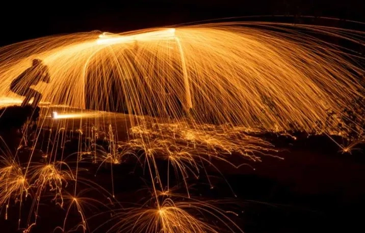 Sparkler and fireworks trails on a black background