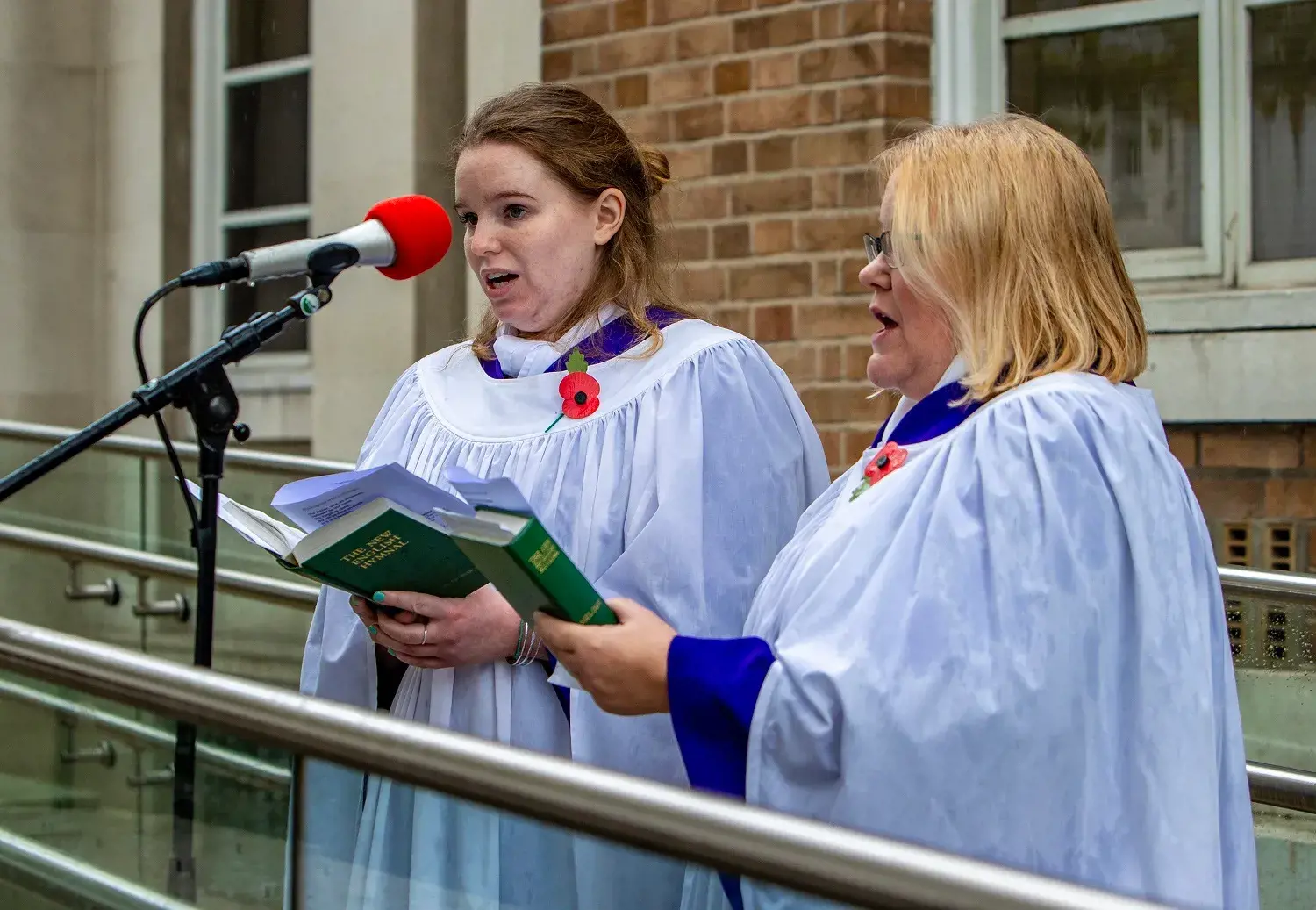 Two ladies singing hymns