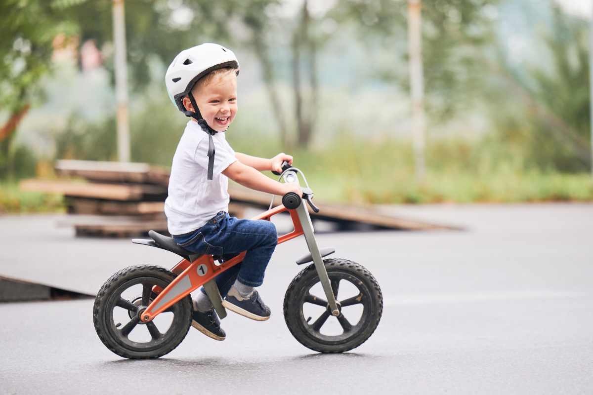 A Child Rides A Balance Bike