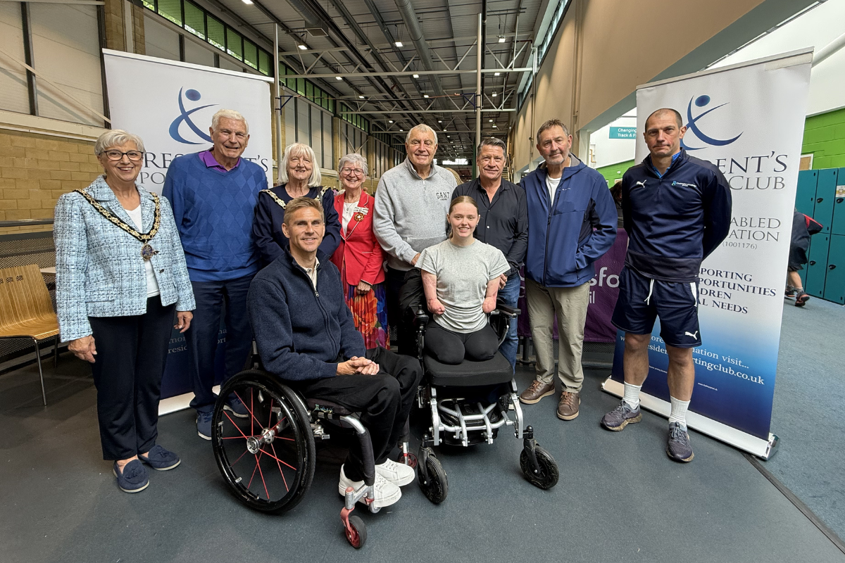 The event's VIP guests with volunteer Paul Miles.png