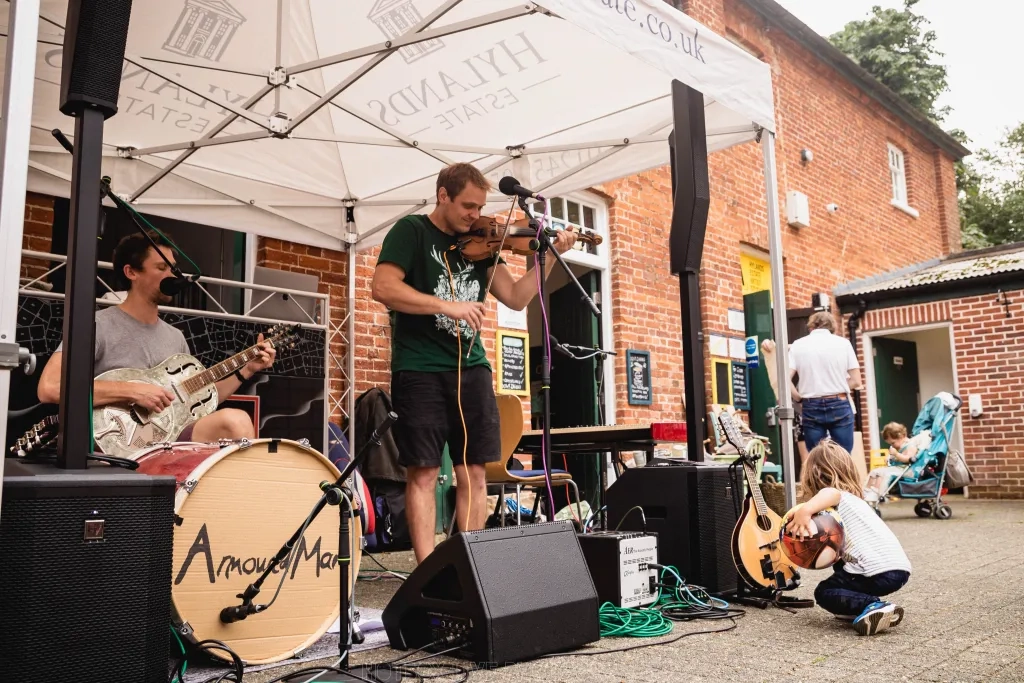 Musicians playing in The Stables courtyard at Hylands Estate