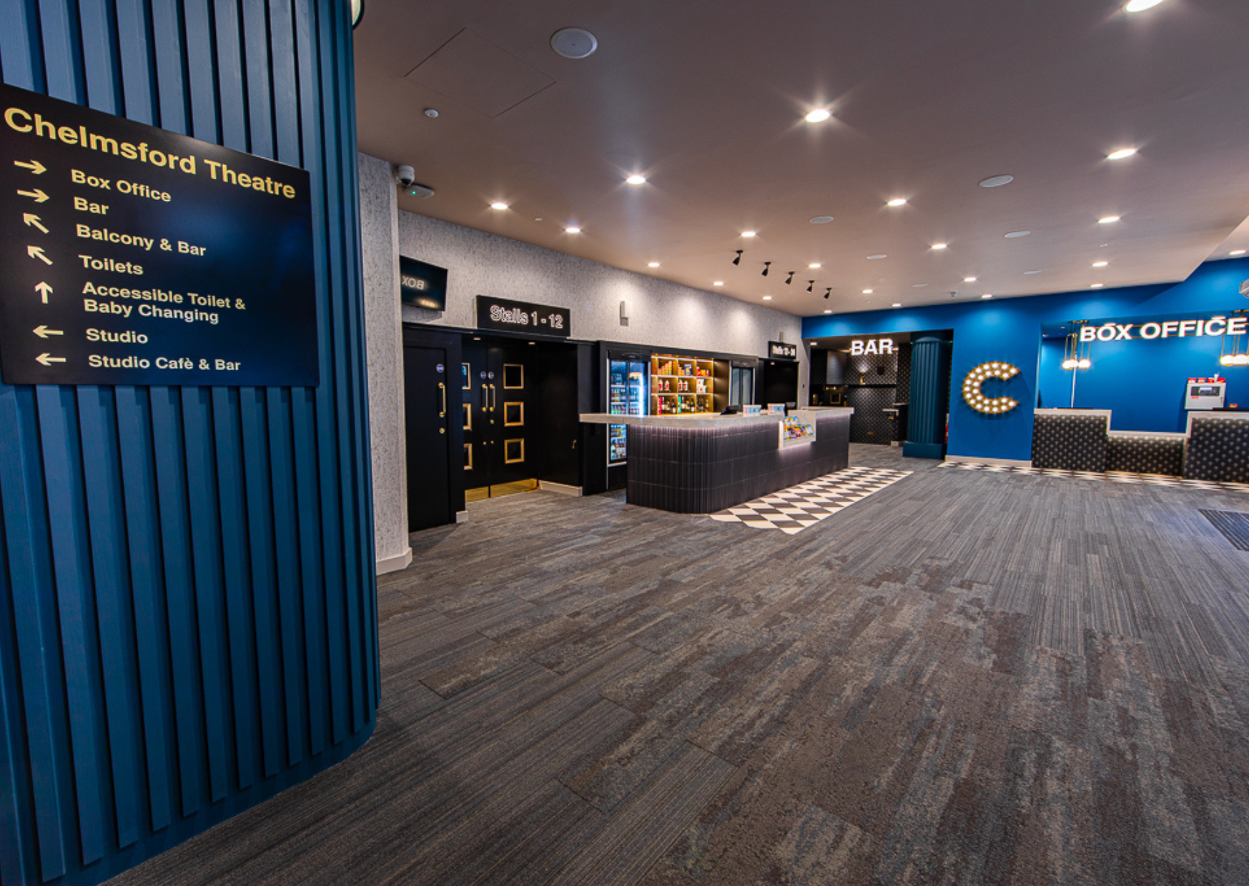 Snack and drinks bar with door to bar and box office desk