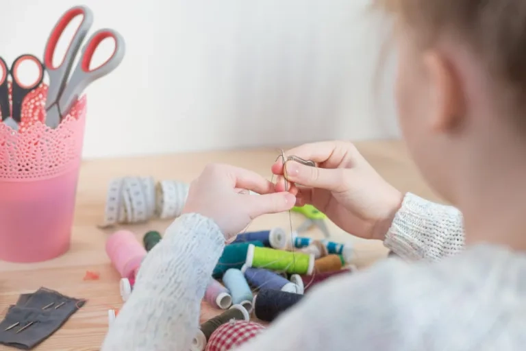 Person threading a needle