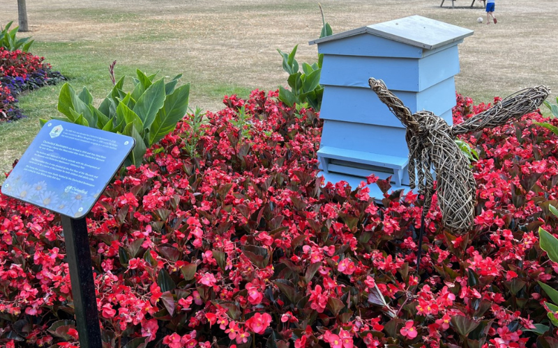 Oaklands bee sculpture beside beehive