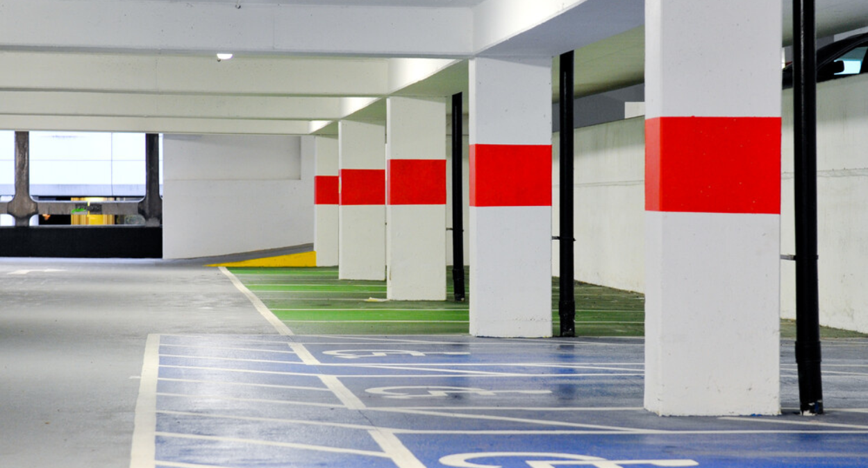 Car park with pillars and blue disabled spaces marked out