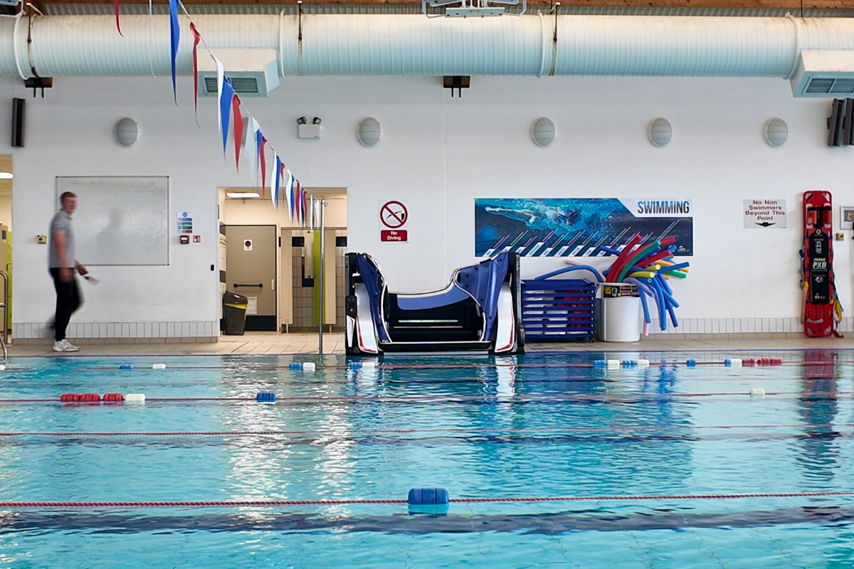 A member of staff walks towards the Poolpod at SWFLC.png