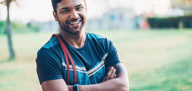 Man laughing with arms folded