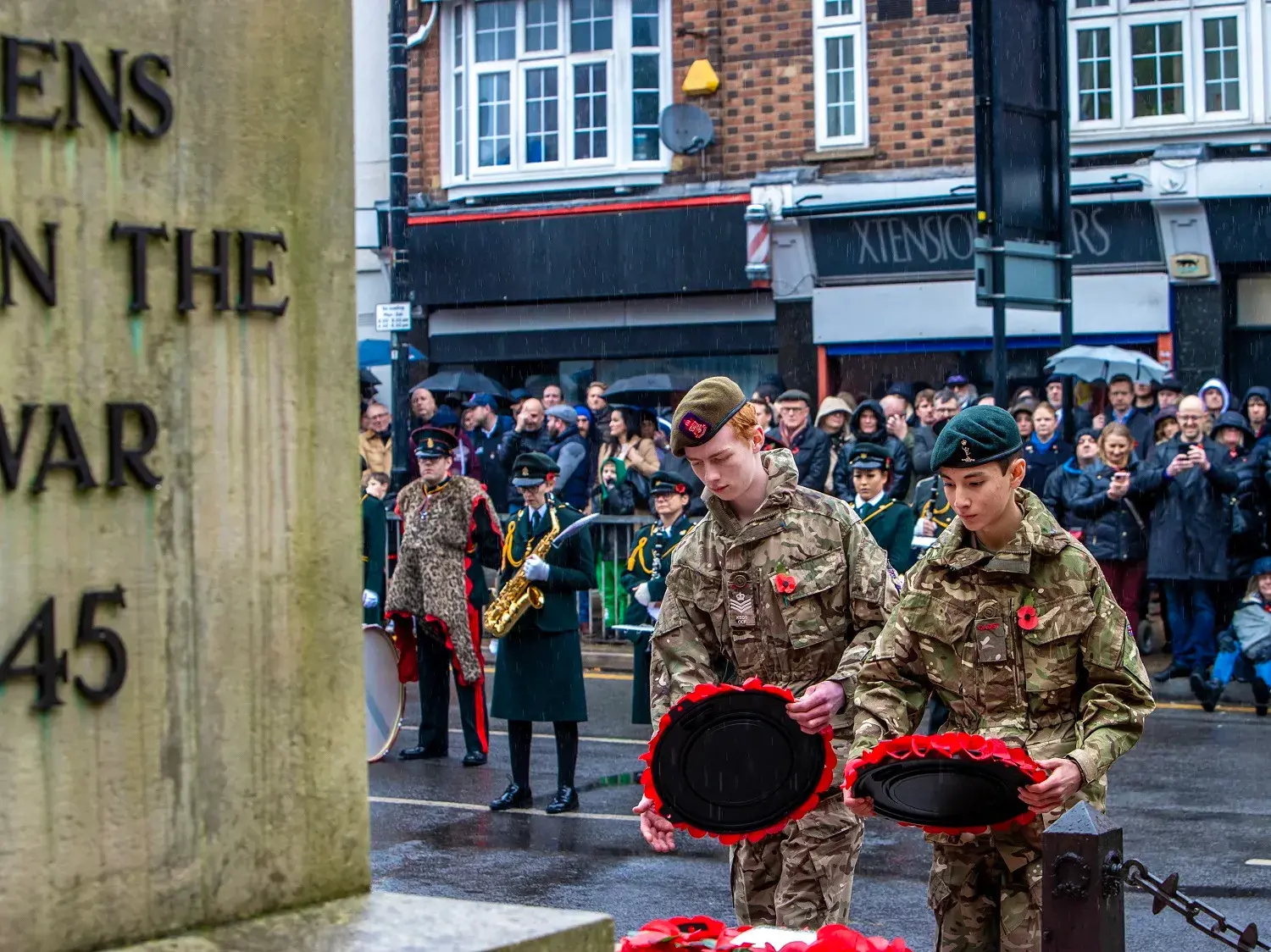 Army cadets laying down wreath at war memorial
