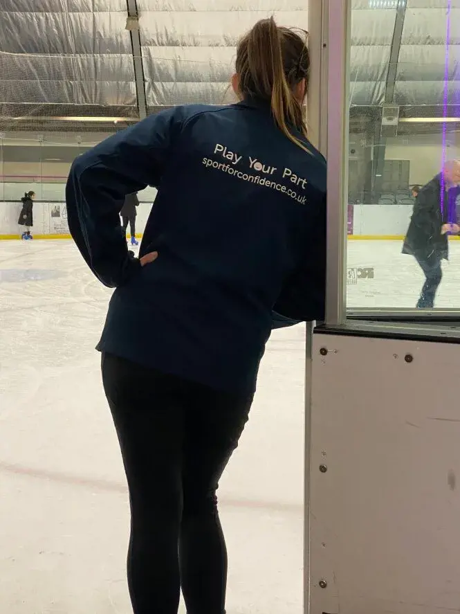 Sport For Confidence Occupational Therapist Watches On During An Accessible Ice Skating Session