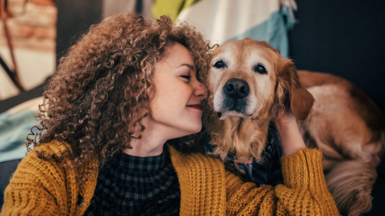 A Woman Snuggles With Her Dog