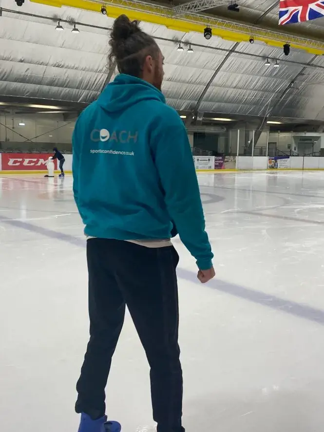 Sport For Confidence Head Coach Watches On During An Accessible Ice Skating Session
