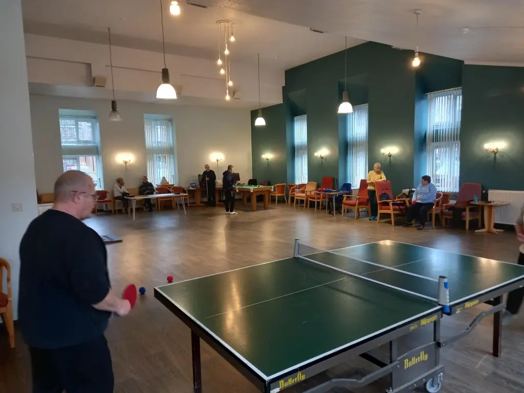 People Playing Table Tennis In Indoor Room