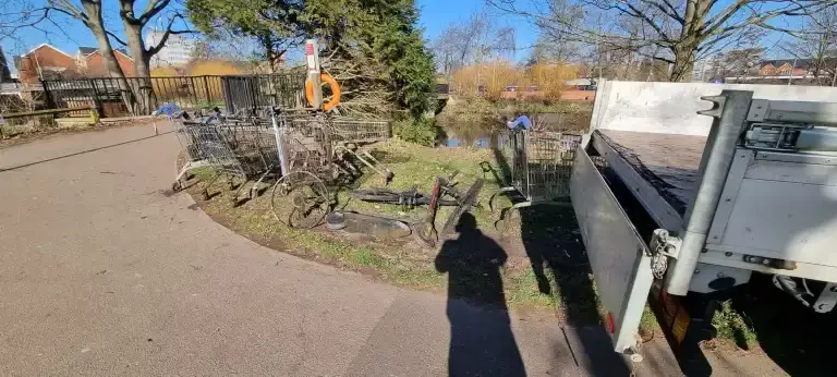Litter pulled from river being loaded into the back of a truck