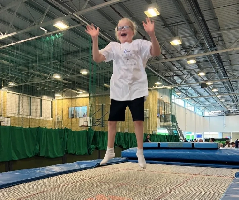 Girl Smiles While Jumping On A Trampoline
